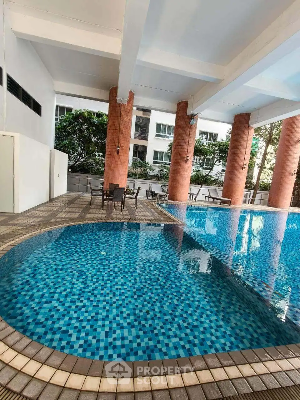 Luxurious residential pool area with stylish seating and modern architecture.