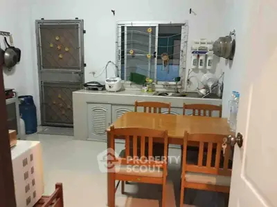 Cozy kitchen with dining table and modern appliances in a compact layout.
