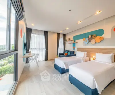Spacious modern bedroom with twin beds and stylish decor, featuring large windows for natural light.