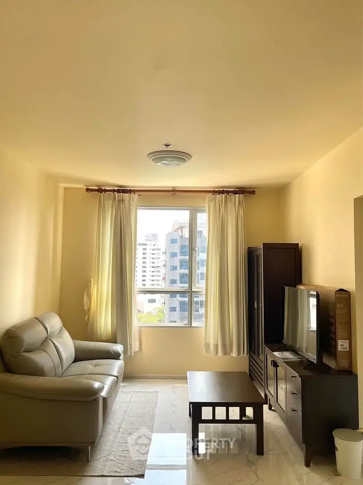 Bright living room with modern furniture and city view from window