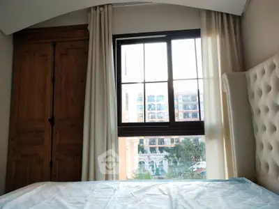 Charming bedroom with rustic wooden wardrobe and large window view