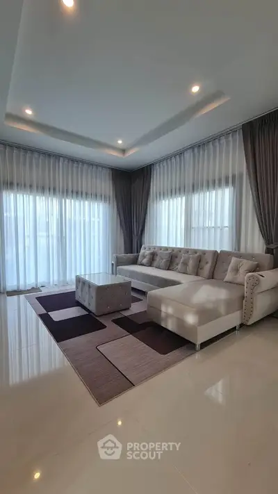 Elegant living room with modern decor and large windows for natural light.
