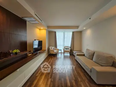 Spacious modern living room with wooden flooring and elegant furniture