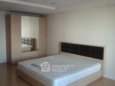 Spacious bedroom with modern wardrobe and comfortable bed
