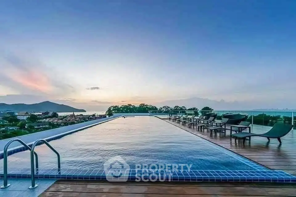 Stunning rooftop pool with panoramic ocean views at sunset, perfect for luxury living.