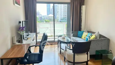 Chic living room with modern decor and city view balcony in urban apartment.
