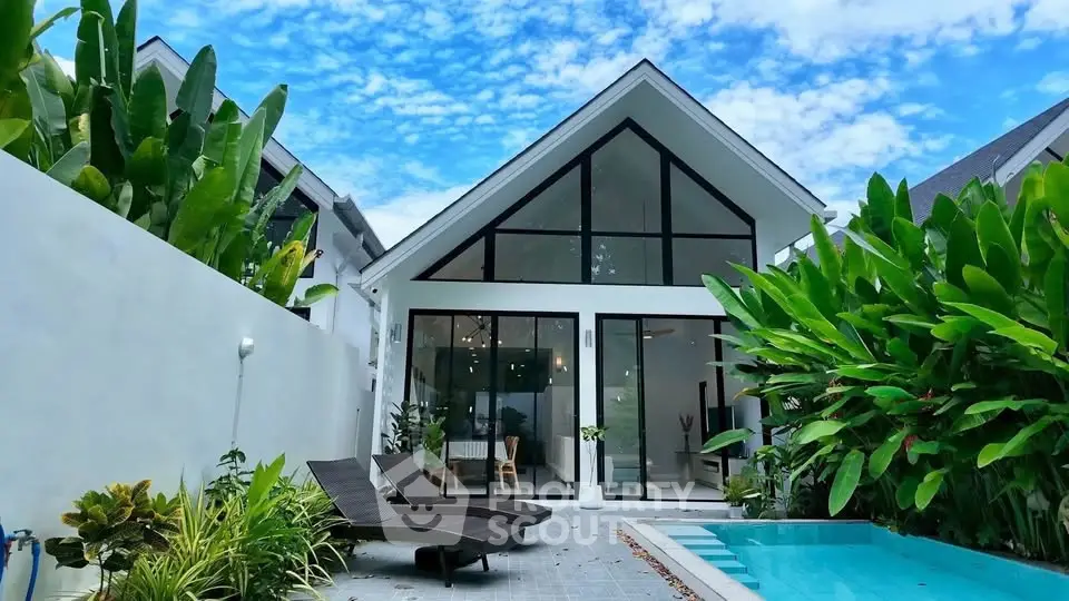 Stunning modern villa with pool and lush garden, featuring sleek architecture and expansive glass windows.