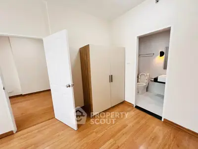 Spacious bedroom with ensuite bathroom and wooden flooring