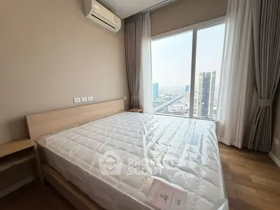 Modern bedroom with city view and air conditioning in high-rise apartment