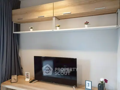 Modern living room with sleek TV setup and stylish wooden cabinets