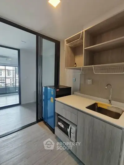 Modern kitchen with open layout and sleek appliances in a stylish apartment.