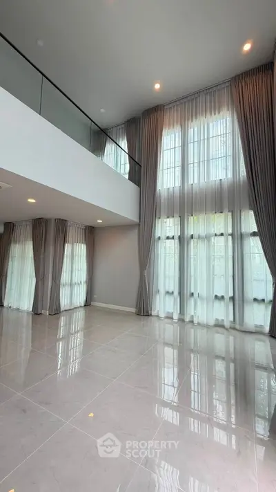 Spacious modern living room with high ceilings and large windows for natural light