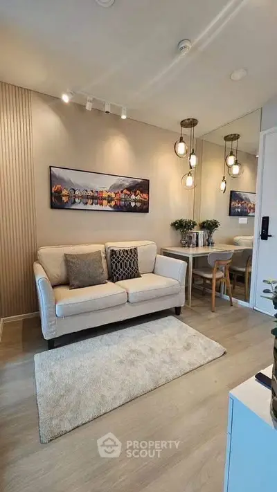 Stylish living room with cozy sofa, elegant lighting, and modern decor in a contemporary apartment.