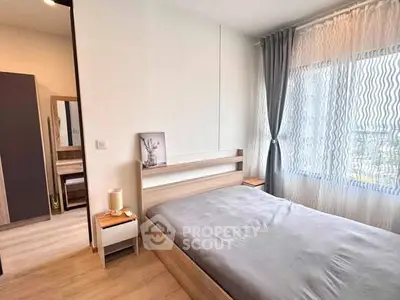 Modern bedroom with large window and stylish decor