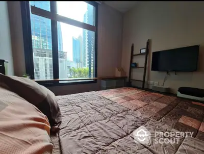 Modern bedroom with city view and wall-mounted TV in luxury apartment