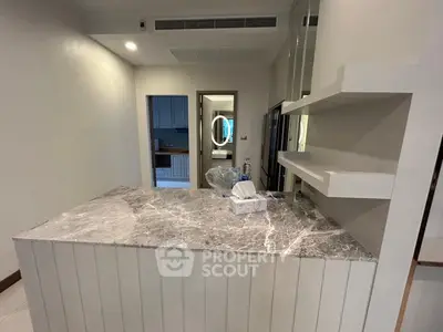 Modern kitchen with marble countertop and open shelving in a stylish apartment.