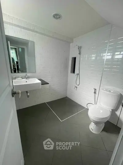 Modern bathroom with sleek white tiles and minimalist fixtures