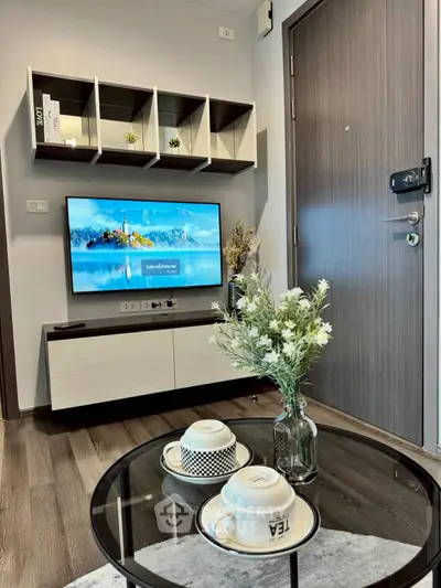 Modern living room with stylish decor and flat-screen TV, perfect for cozy evenings.