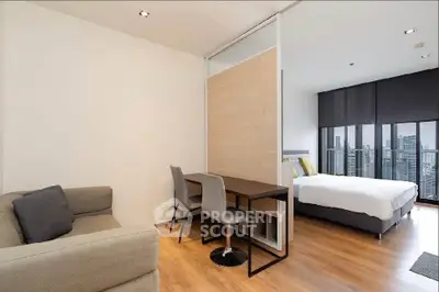 Modern studio apartment with city view, featuring cozy living area and stylish bedroom.