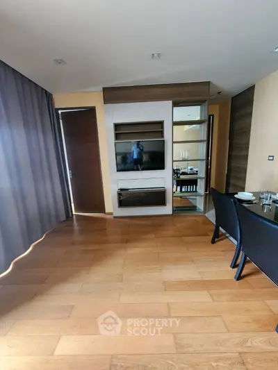 Modern living room with wooden flooring and sleek dining area