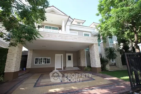 Stunning two-story house with spacious driveway and lush greenery.