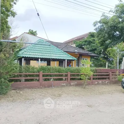 Charming suburban house with green roof and lush garden