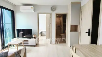 Modern living room with natural light, sleek furniture, and open layout in a stylish apartment.