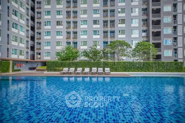 Luxurious apartment complex with a stunning outdoor pool and modern design.