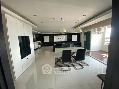 Spacious modern living room with sleek dining area and balcony access, perfect for entertaining.