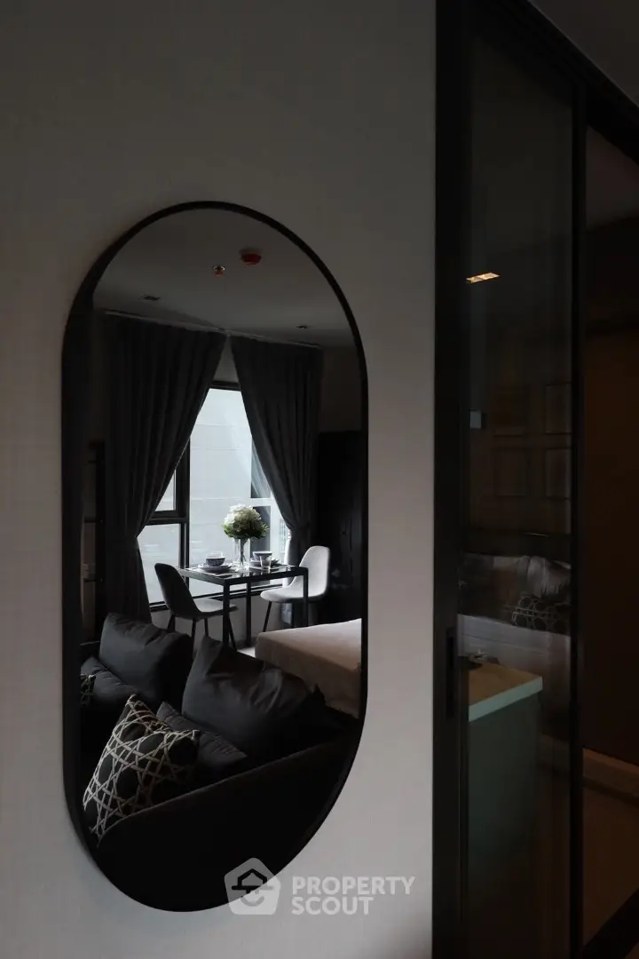 Stylish modern living room with elegant decor and large window view.