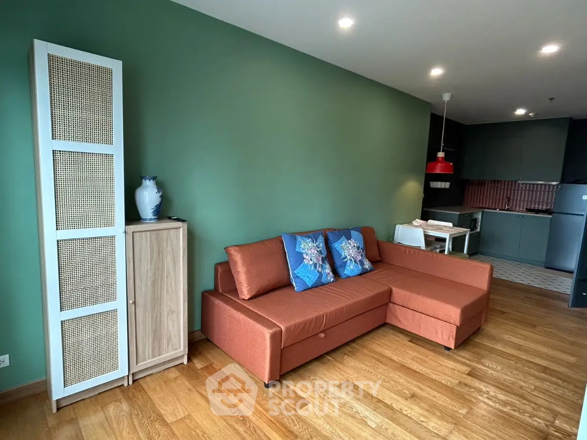 Modern living room with stylish sofa and open kitchen layout