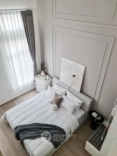 Modern minimalist bedroom with stylish decor and natural light