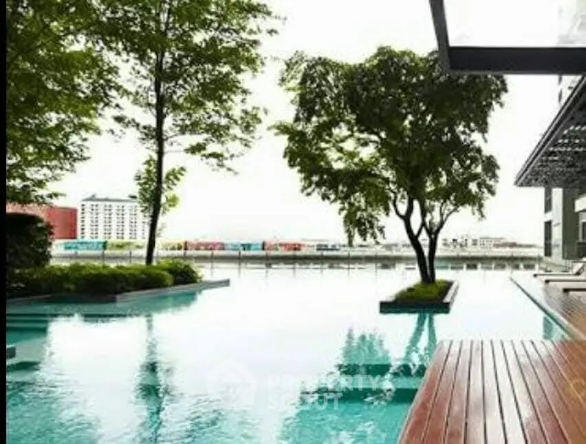 Luxurious modern poolside area with serene water views and lush greenery.