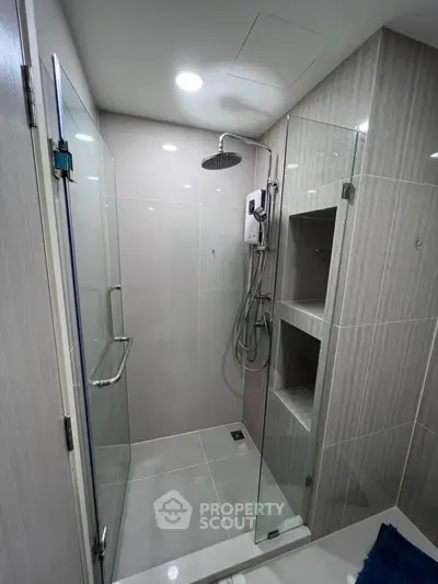Modern bathroom with glass shower enclosure and sleek tile design