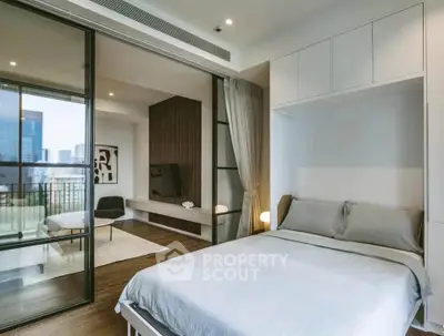 Modern bedroom with sliding glass doors leading to a spacious balcony and city view.
