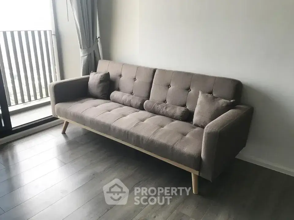 Modern living room with stylish sofa and balcony view