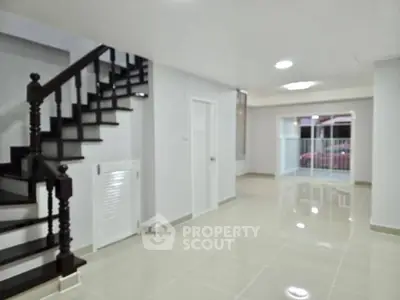 Spacious modern interior with elegant staircase and open layout, perfect for family living.