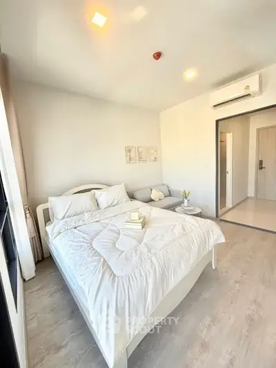 Modern bedroom with cozy white bedding and natural light