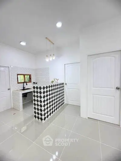 Modern kitchen with checkered island and sleek white tiles
