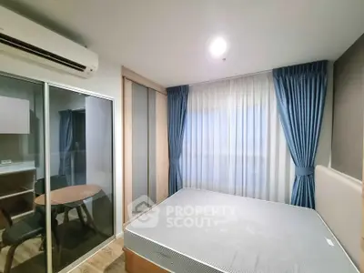 Modern bedroom with large window, blue curtains, and sliding glass doors for a spacious feel.