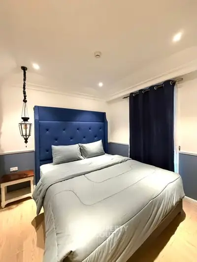 Cozy bedroom with elegant blue accents and modern lighting