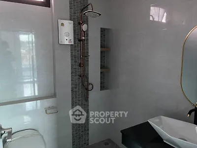 Modern bathroom with sleek shower and stylish fixtures in a contemporary home.