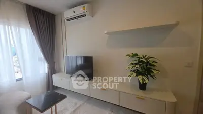 Modern living room with sleek TV unit and air conditioning, perfect for urban living.