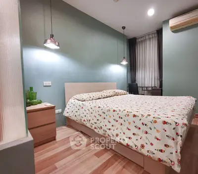 Cozy bedroom with modern decor and stylish lighting, featuring a comfortable bed and wooden flooring.