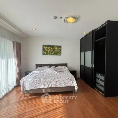 Spacious bedroom with modern decor and ample natural light