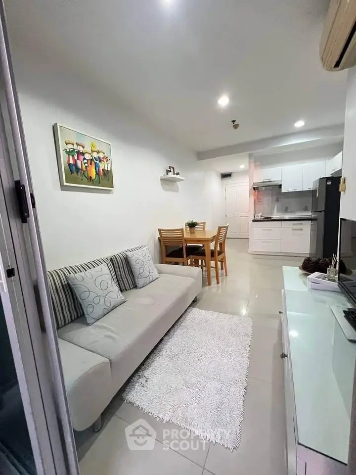 Modern living room with open kitchen layout and stylish decor