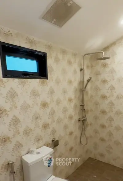 Elegant bathroom with modern shower and stylish wallpaper