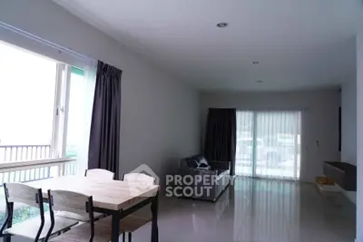 Spacious living room with modern furniture and large windows for natural light.