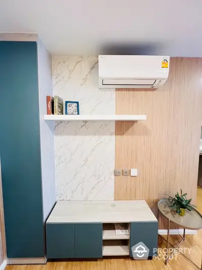 Modern living room with air conditioning and stylish shelving