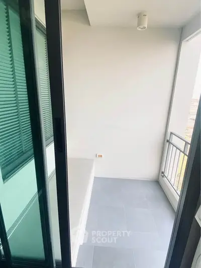 Modern balcony with sleek design and glass sliding doors, perfect for relaxation and enjoying the view.